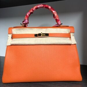 Hermes. Kelly in luxurious orange togo leather.